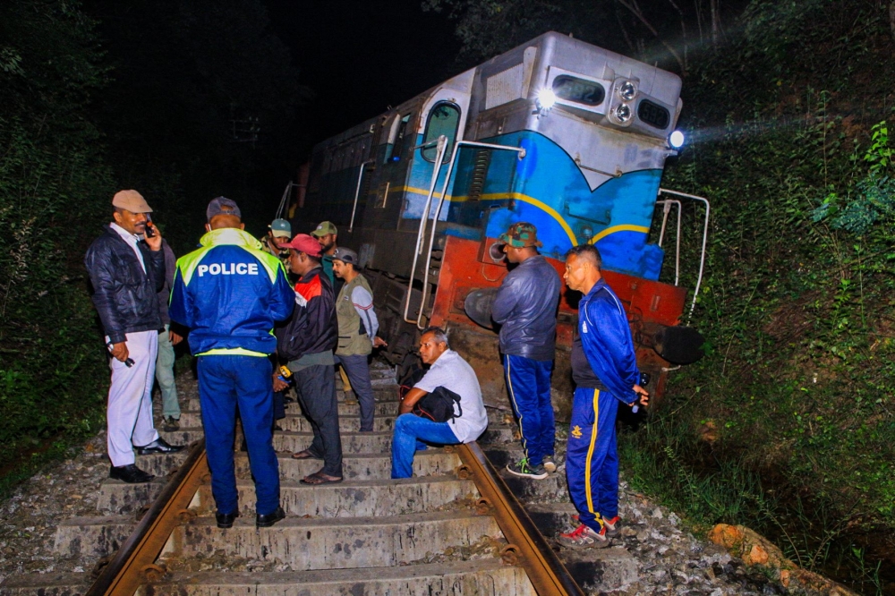 Police and railway personnel examine a derailed train at Habarana in eastern Sri Lanka on February 20, 2025, which killed six elephants. (Photo by AFP)