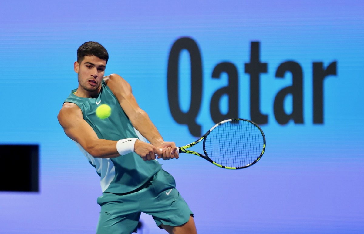 Spain's Carlos Alcaraz hits a return against Italy's Luca Nardi.