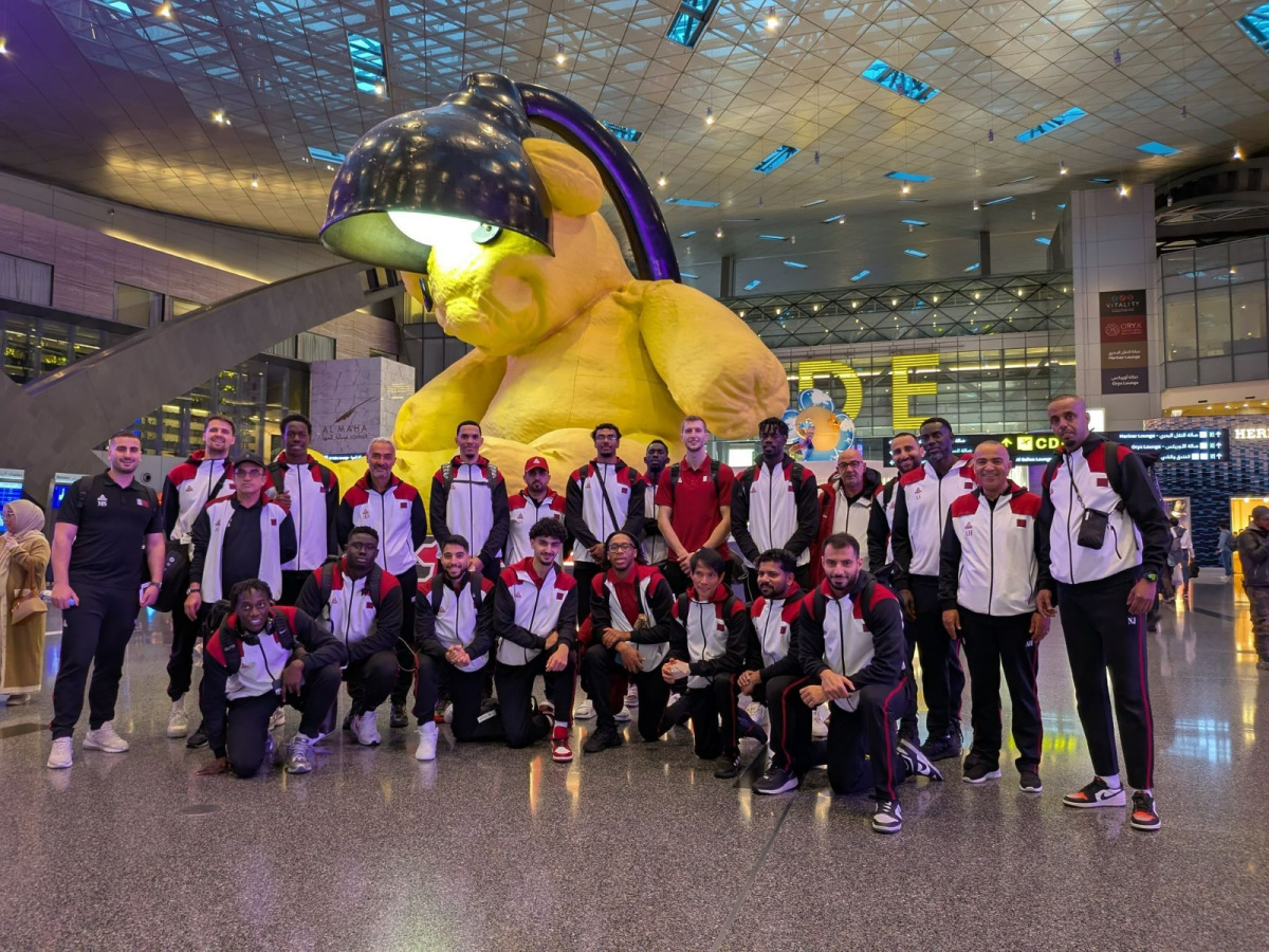 Qatar basketball team's players and officials pose for a photo prior to their departure for Astana.