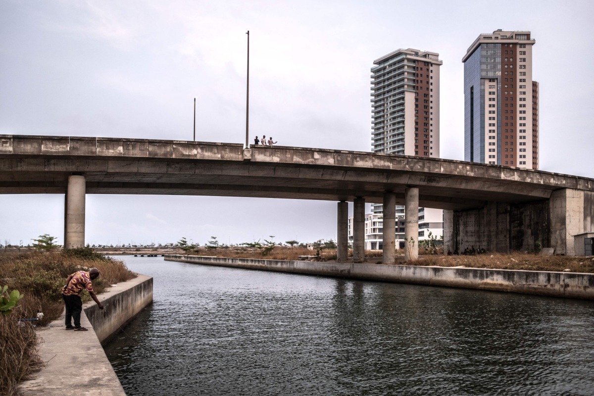 A man fishes inside the Eko Atlantic city project in Lagos, on February 19, 2025. (Photo by OLYMPIA DE MAISMONT / AFP)