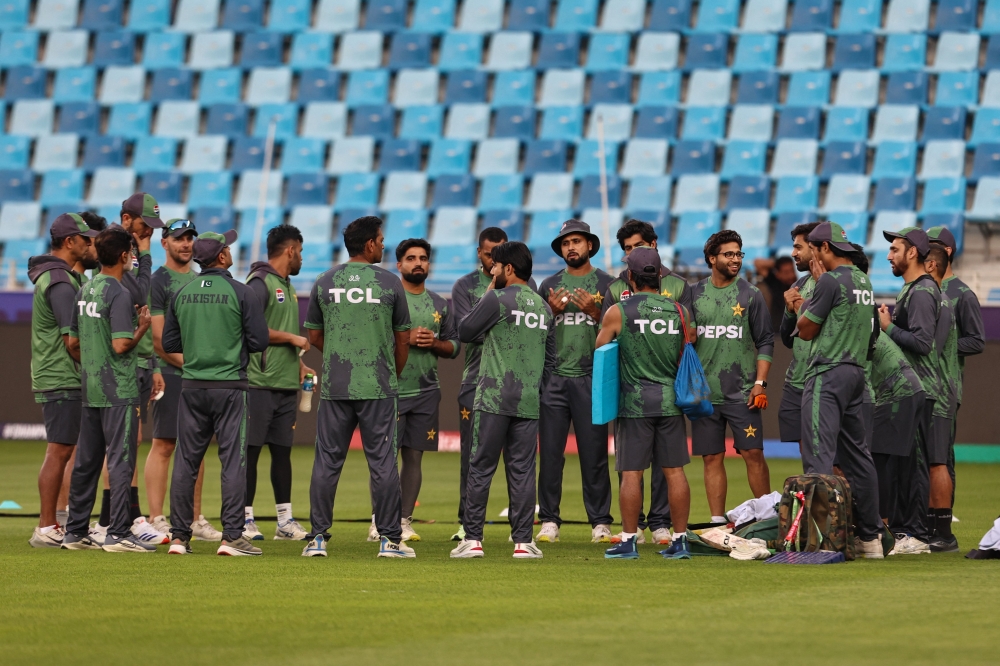 Pakistan's players huddle during a practice session at the Dubai International Stadium in Dubai on February 22, 2025. (Photo by Fadel Senna / AFP)