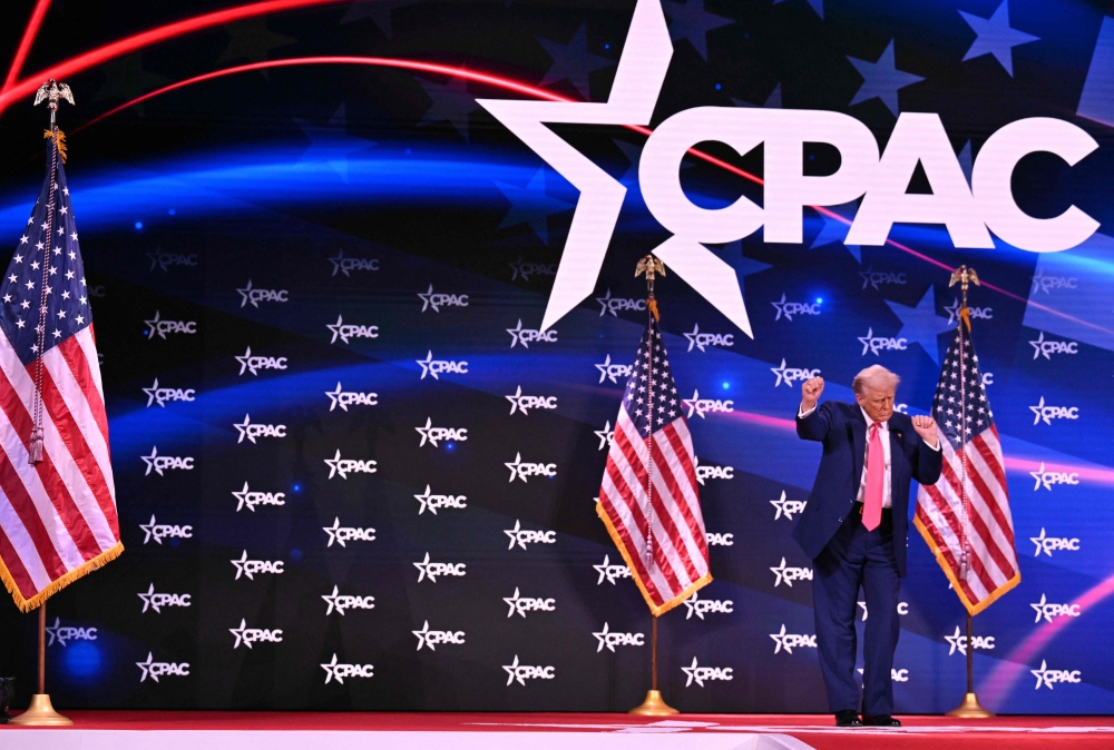 US President Donald Trump dances after speaking at the annual Conservative Political Action Conference (CPAC) in Oxon Hill, Maryland, on February 22, 2025. (Photo by Roberto Schmidt / AFP)