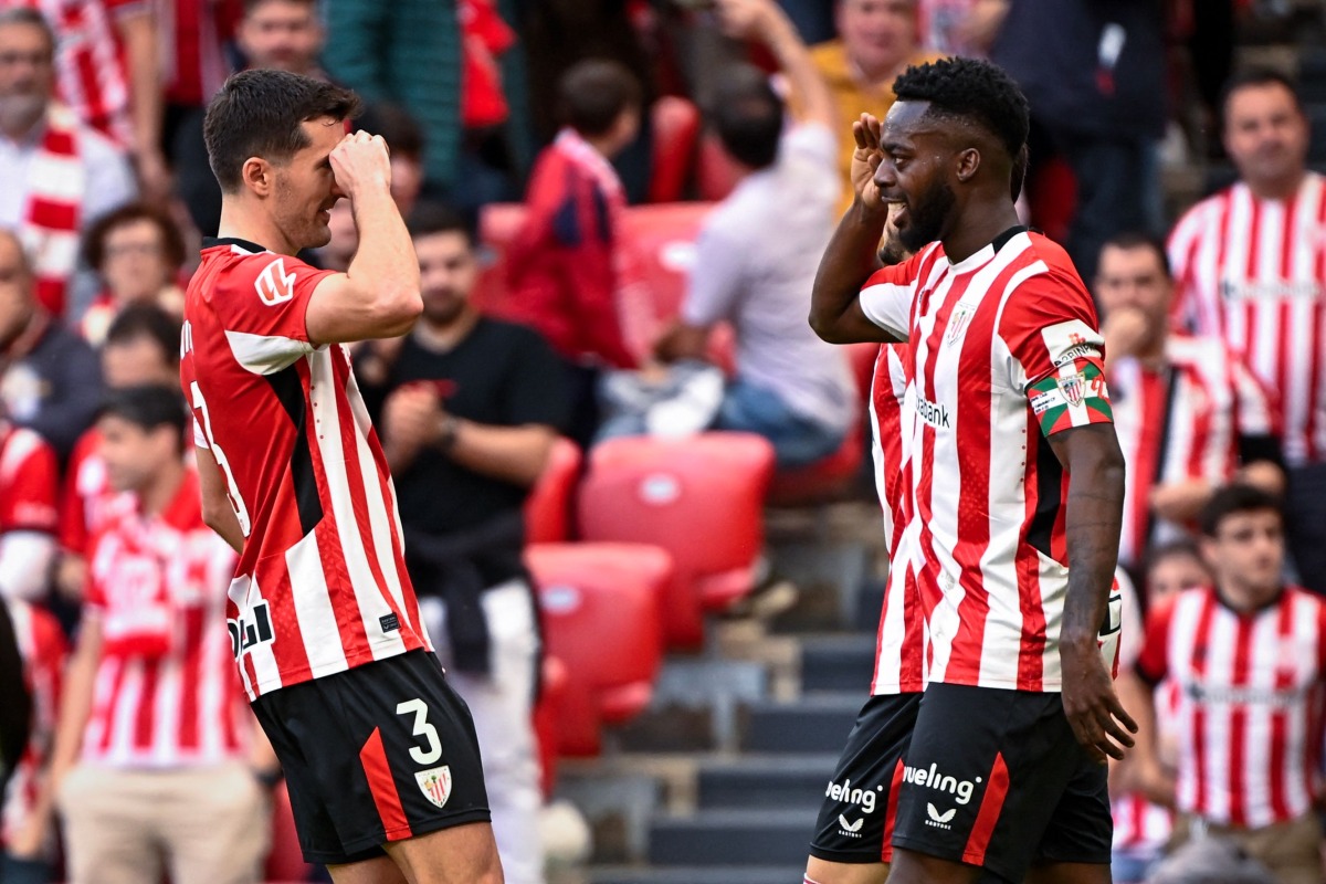 Athletic Bilbao's Spanish forward #09 Inaki Williams (R) celebrates with Athletic Bilbao's Spanish defender #04 Aitor Paredes after scoring their seventh goal during the Spanish league football match between Athletic Club Bilbao and Real Valladolid FC at San Mames Stadium in Bilbao on February 23, 2025. (Photo by ANDER GILLENEA / AFP)
