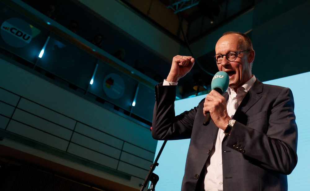 Friedrich Merz, leader of Germany's conservative Christian Democratic Union (CDU) and his party's main candidate for Chancellor addresses supporters at the electoral evening in Berlin on February 23, 2025. (Photo by Odd Andersen / AFP)