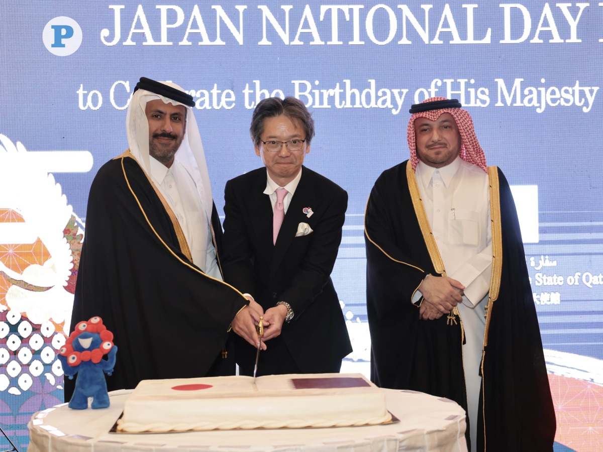 Minister of Commerce and Industry H E Sheikh Faisal bin Thani bin Faisal Al Thani (left); Director of MoFA Protocol Department H E Ambassador Ibrahim Yousif Abdullah Fakhro (right); and Ambassador of Japan H E Naoto Hisajima cut the cake at the reception yesterday. Pic: Ahmed Barakat/The Peninsula  