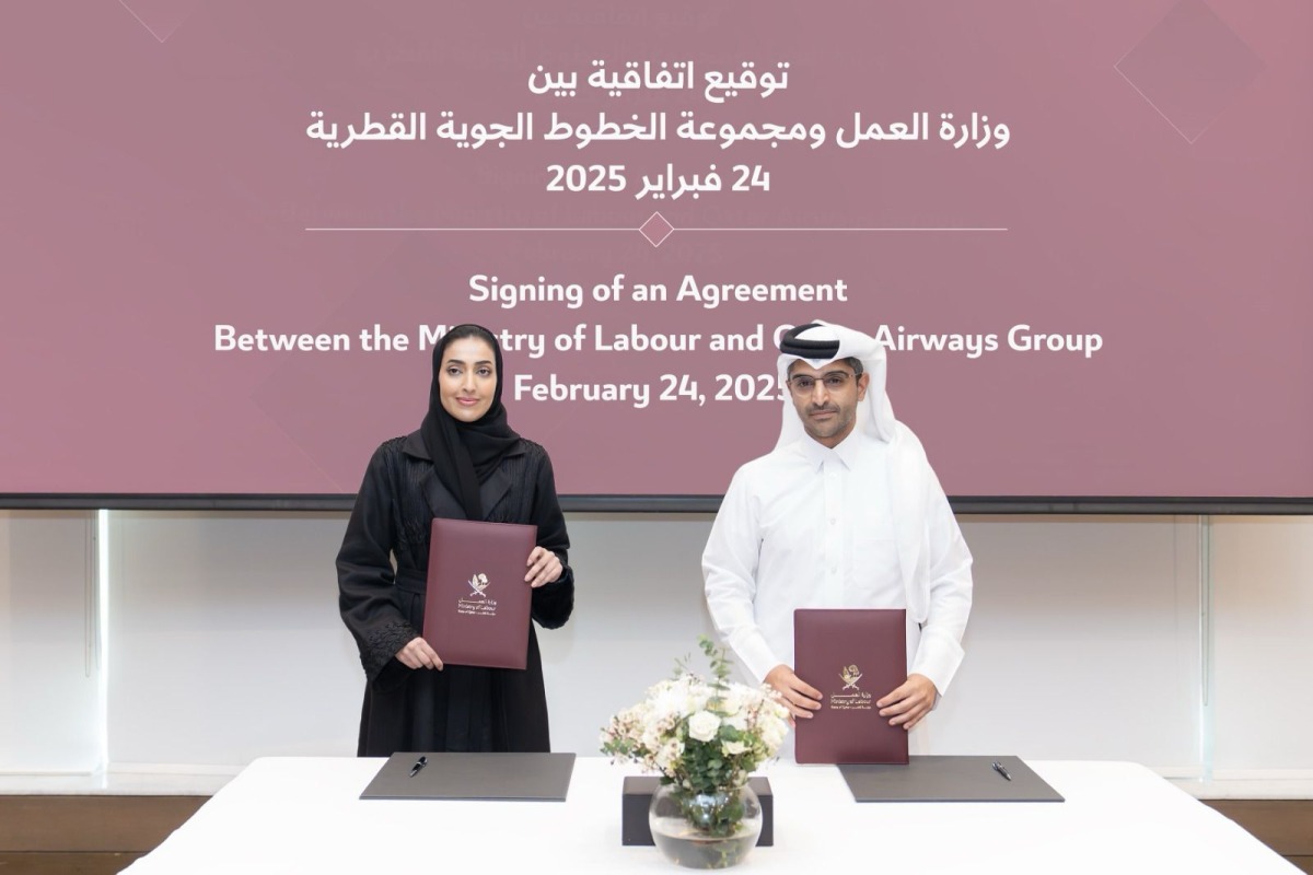 Shaikha Abdulrahman Al Badi, Assistant Undersecretary for National Manpower Affairs in the Private Sector at the Ministry of Labour, and Mohammed Abdullah Fakhroo, Vice-President of Nationalisation and Strategic Relations at Qatar Airways Group exchanging documents after signing the agreement.