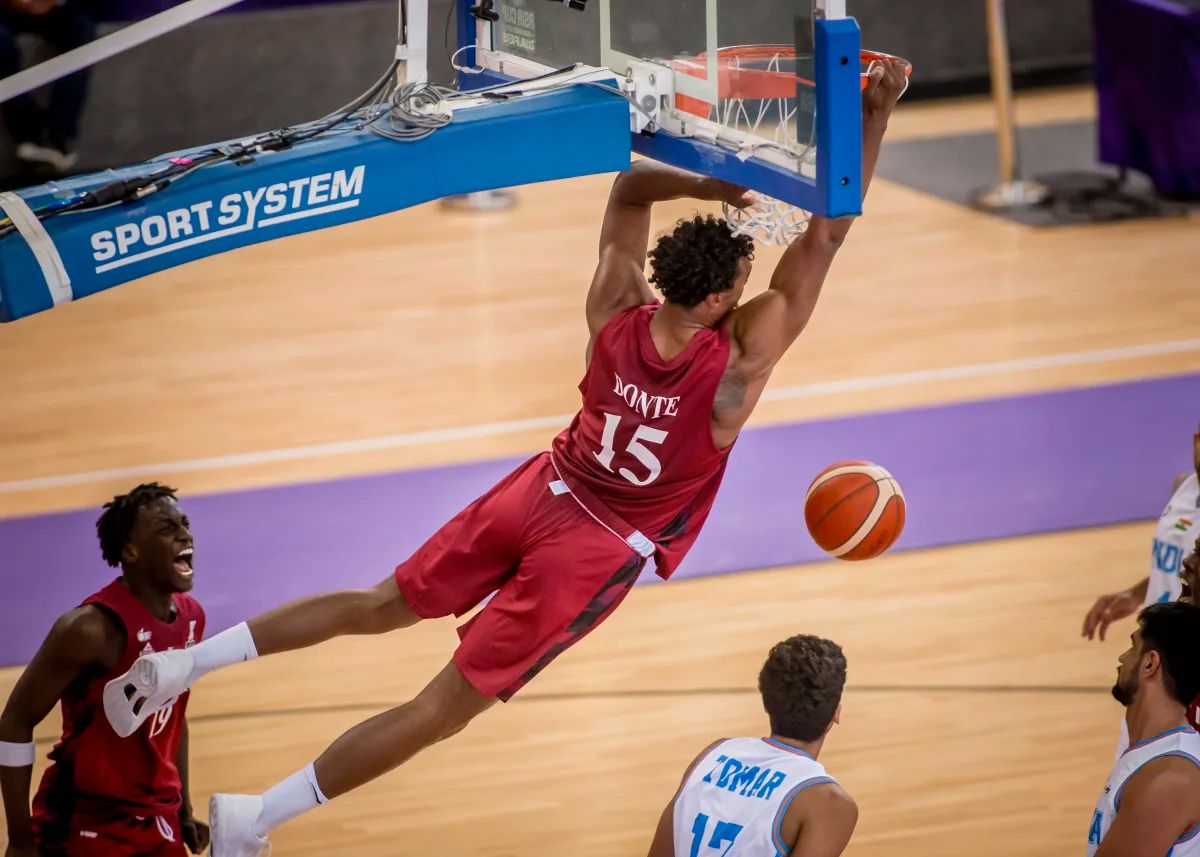 Qatar's Donte Grantham Mustafa Ndaw dunks the ball during the match.