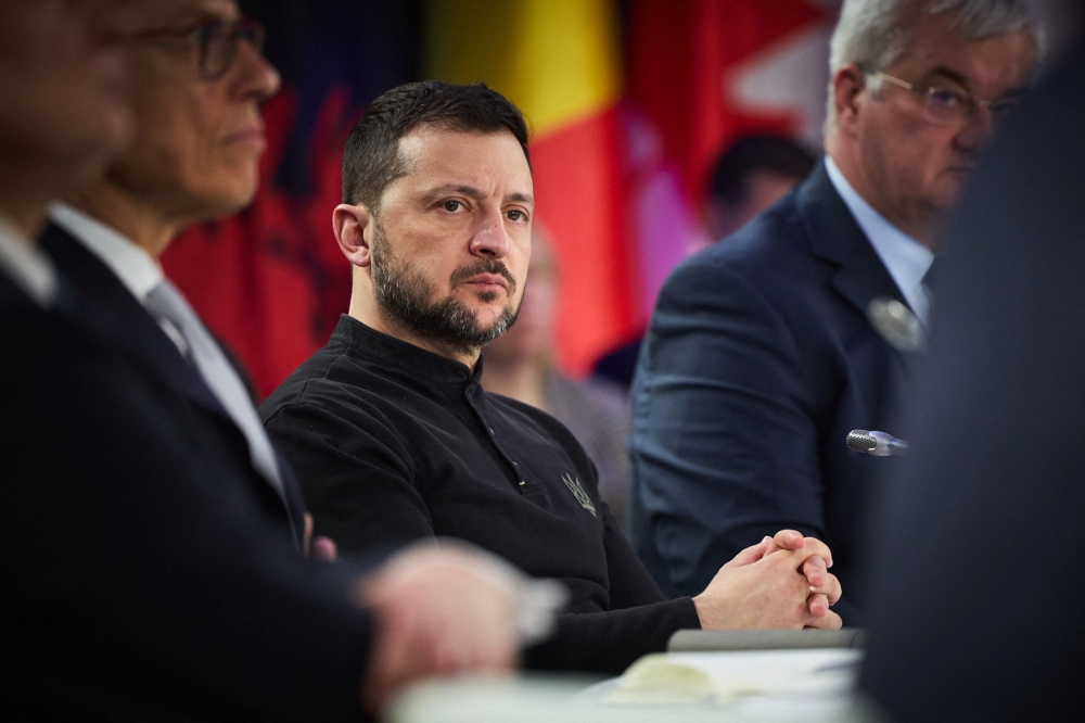 In this handout photograph taken and released by the Ukrainian Presidential Press Service on February 24, 2025, Ukraine's President Volodymyr Zelensky attends a meeting with European leaders and Canada's prime minister Justin Trudeau in Kyiv, to mark the third anniversary of the Russian invasion of Ukraine. (Photo by Handout / Ukrainian Presidential Press Service / AFP)
