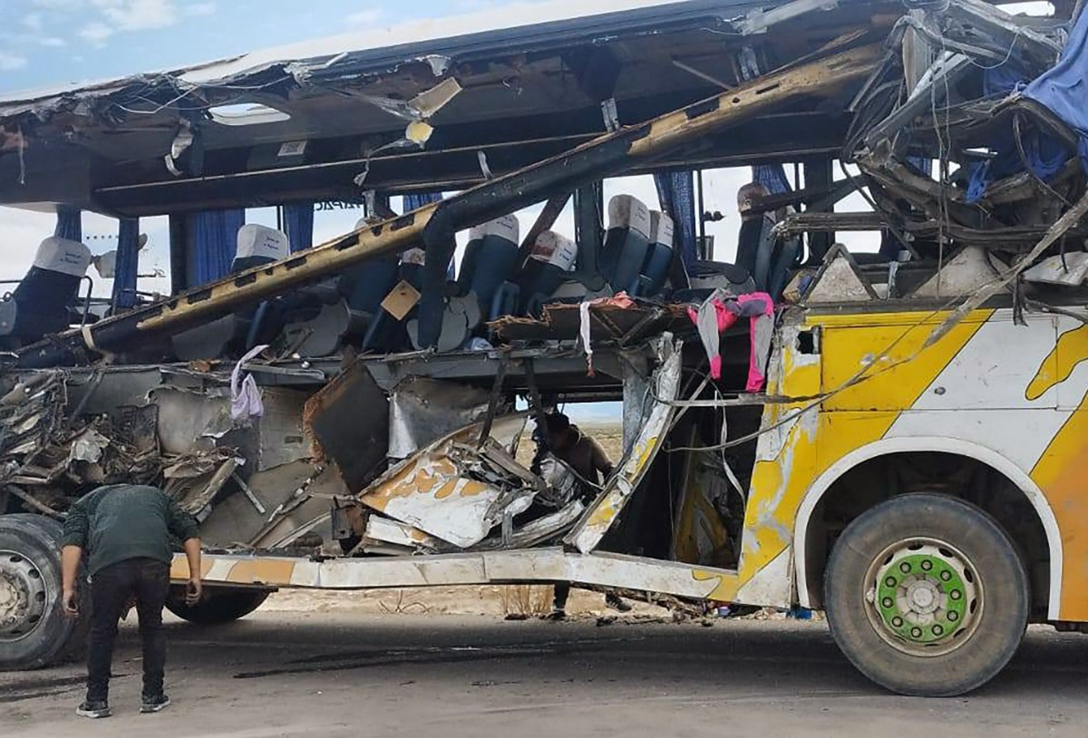 Handout picture released by Bolivian Police shows a man checking the wreckage of a bus that collided with another one on a highway near Uyuni, Bolivia on March 1, 2025. Photo by Handout / Bolivian Police / AFP