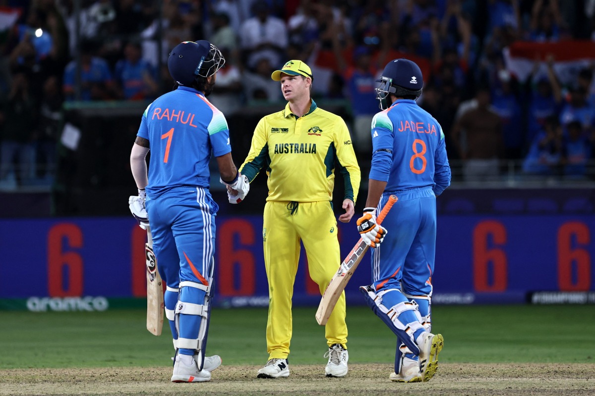 Australia's captain Steve Smith (C) shakes hands with India's KL Rahul as India's Ravindra Jadeja (R) watches at the end of the ICC Champions Trophy one-day international (ODI) semi-final cricket match between Australia and India at the Dubai International Stadium in Dubai on March 4, 2025. (Photo by FADEL SENNA / AFP)
