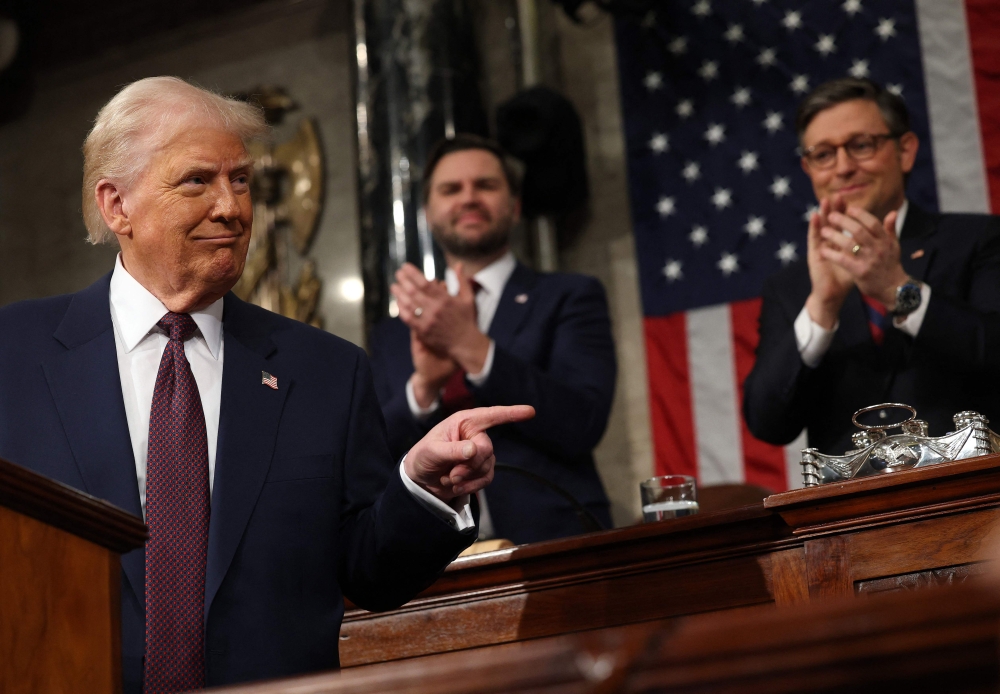 US Vice President JD Vance and Speaker of the House Mike Johnson (R-LA) applaud as US President Donald Trump speaks during an address to a joint session of Congress in the House Chamber of the US Capitol in Washington, DC, on March 4, 2025. (Photo by Win McNamee / POOL / AFP)