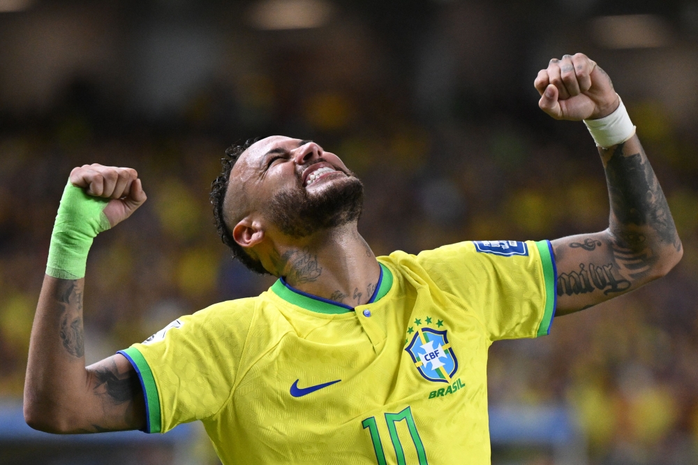 File: Brazil's forward Neymar (left) celebrates after scoring a goal during the 2026 FIFA World Cup South American qualifiers football match between Brazil and Bolivia at the Jornalista Edgar Proença 'Mangueirao' stadium, in Belem, state of Para, Brazil, on September 8, 2023. (Photo by Carl De Souza / AFP)