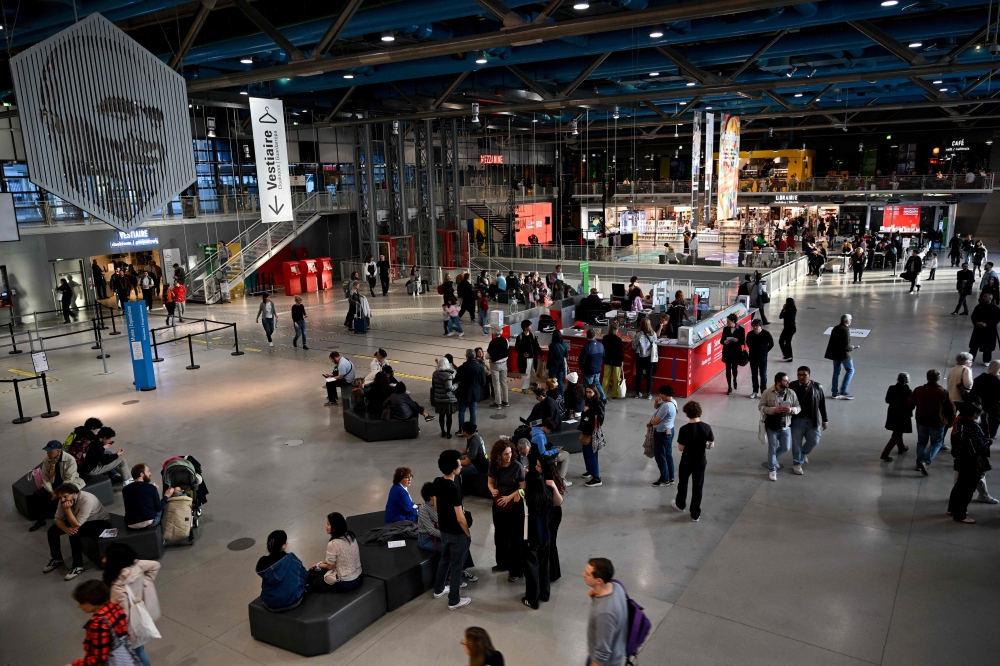 Visitors stroll through the Centre national d'art et de culture Georges-Pompidou (Centre Pompidou) in Paris on March 8, 2025. (Photo by Anna Kurth / AFP)