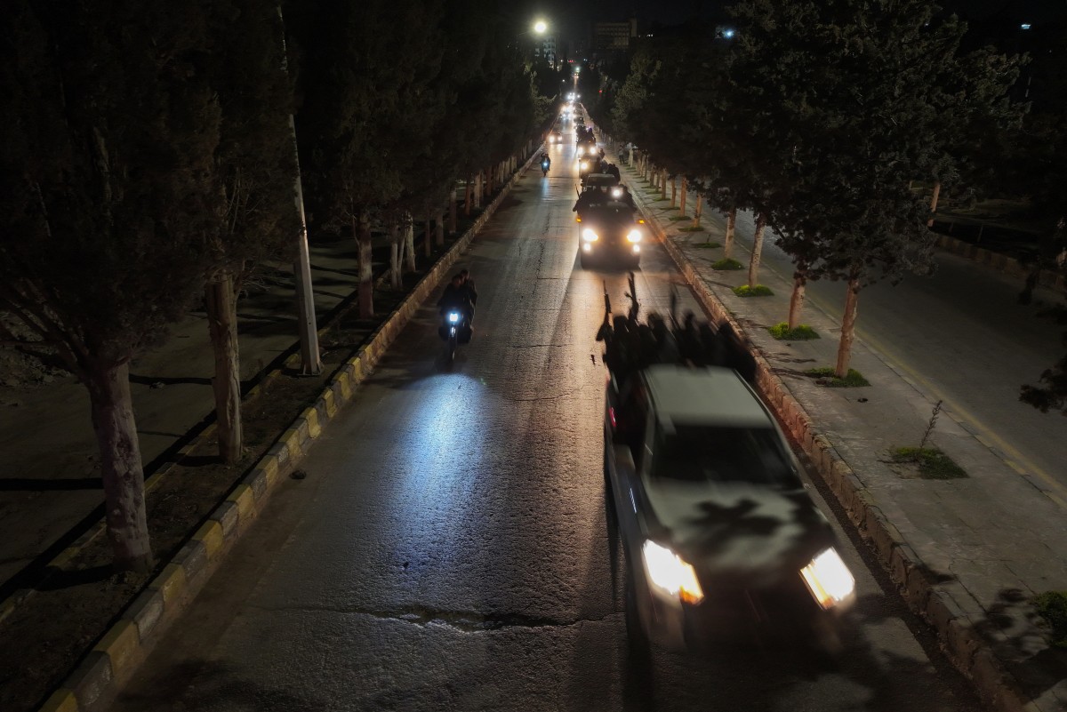 A convoy of Syria's new security forces departs from the northwestern city of Idlib, as reinforcement for the coastal area on March 8, 2025. Photo by Omar HAJ KADOUR / AFP.
