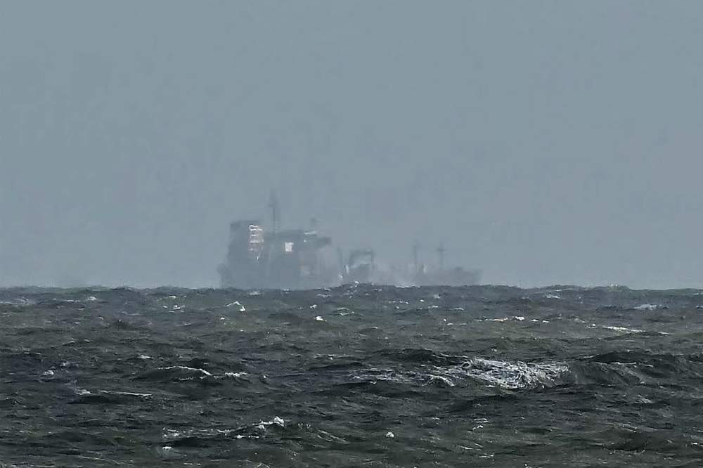 The Stena Immaculate tanker that collided with Solong container vessel appear at a distance off the coast of Withernsea, east of England, on March 11, 2025. (Photo by Paul Ellis / AFP)