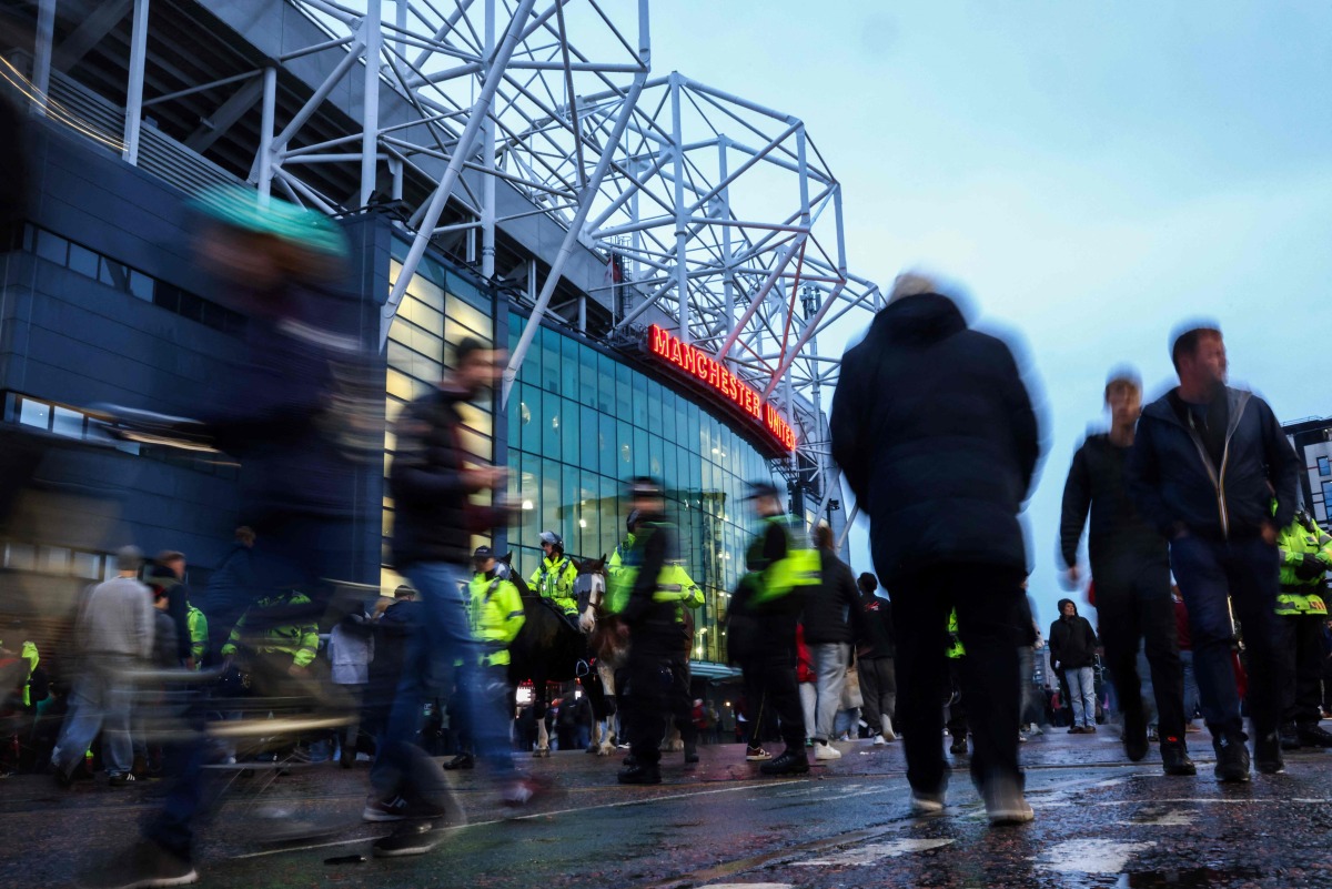 Football fans arrive ahead of the UEFA Europa league stage football match between Manchester United and FC Twente at Old Trafford stadium in Manchester, northwest England, on September 25, 2024. Photo by Darren Staples / AFP