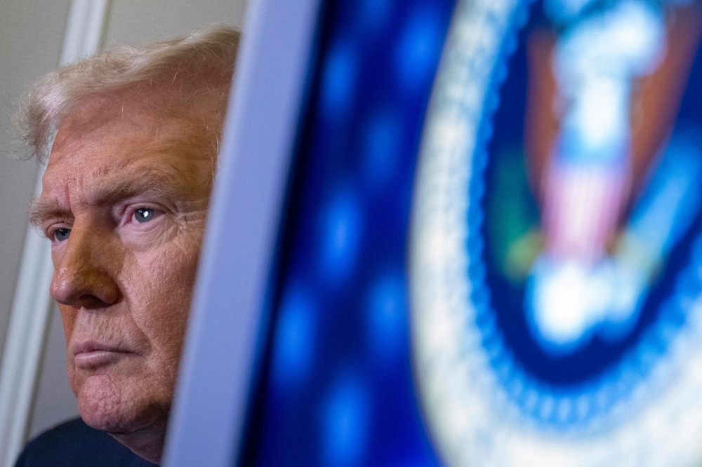 US President Donald Trump speaks to journalists aboard Aire Force One as he travels from West Palm Beach back to Washington on March 9, 2025. (Photo by Roberto Schmidt / AFP)
