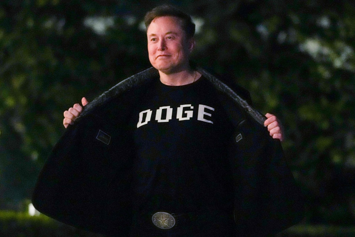 Elon Musk shows off a shirt that says 