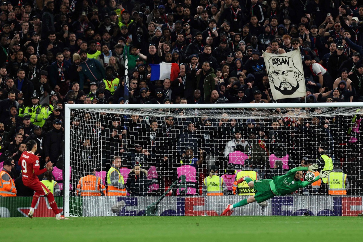 Paris Saint-Germain's Italian goalkeeper #01 Gianluigi Donnarumma stops the penalty shot by Liverpool's Uruguayan striker #09 Darwin Nunez (L) during the last 16 second leg UEFA Champions League football match between Liverpool and Paris Saint-Germain (PSG) at Anfield in Liverpool, north west England on March 11, 2025. (Photo by Darren Staples / AFP)
