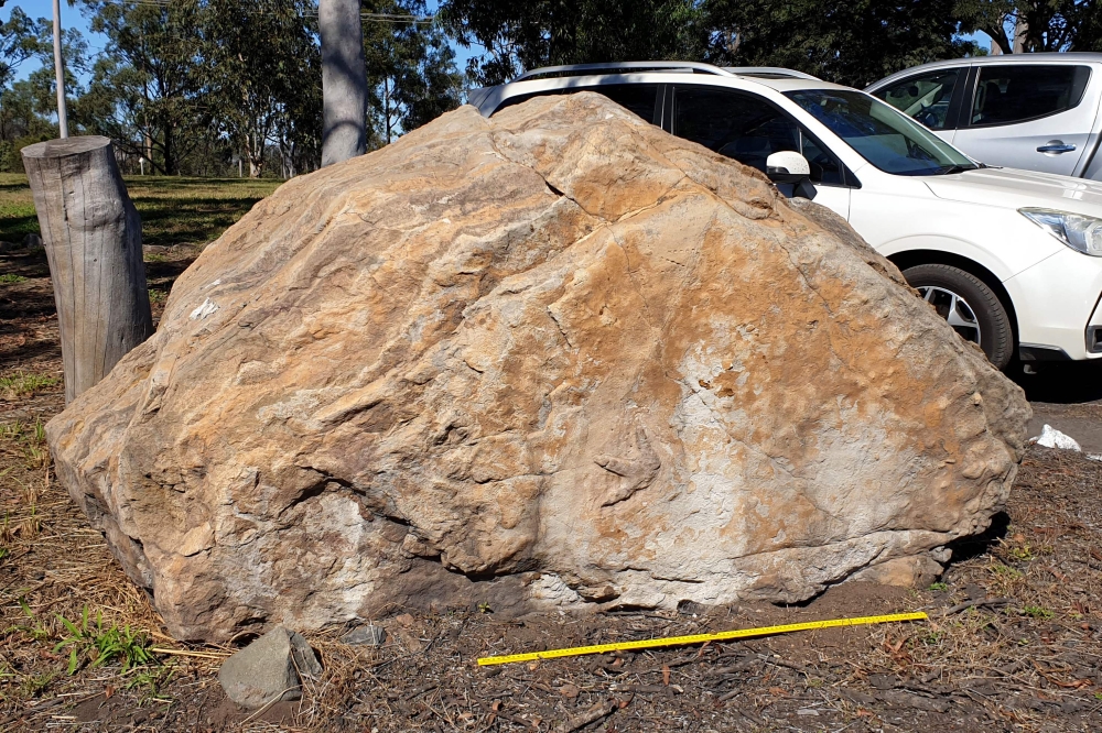 This undated handout photo released on March 12, 2025 shows a boulder sitting outside a school containing dinosaur footprints, in the town of Biloela. (Photo by Handout / University of Queensland / AFP) 