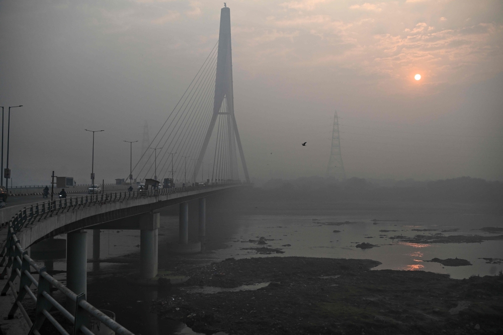 (Files) A general view shows the Signature Bridge over the Yamuna River on a smoggy winter morning in New Delhi on December 20, 2024. (Photo by Arun Sankar / AFP)