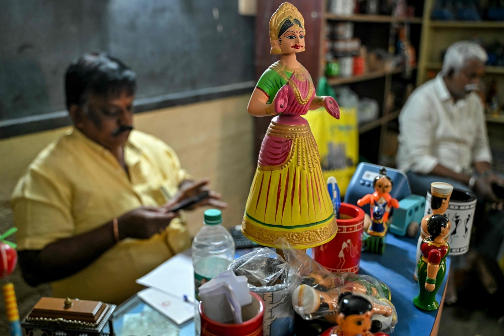 A hand-painted Channapatna doll displayed for sale at artisan Venkatesh's toy store in Channapatna in the Ramanagara district of India's Karnataka state. (Photo by Idrees Mohammed / AFP) 