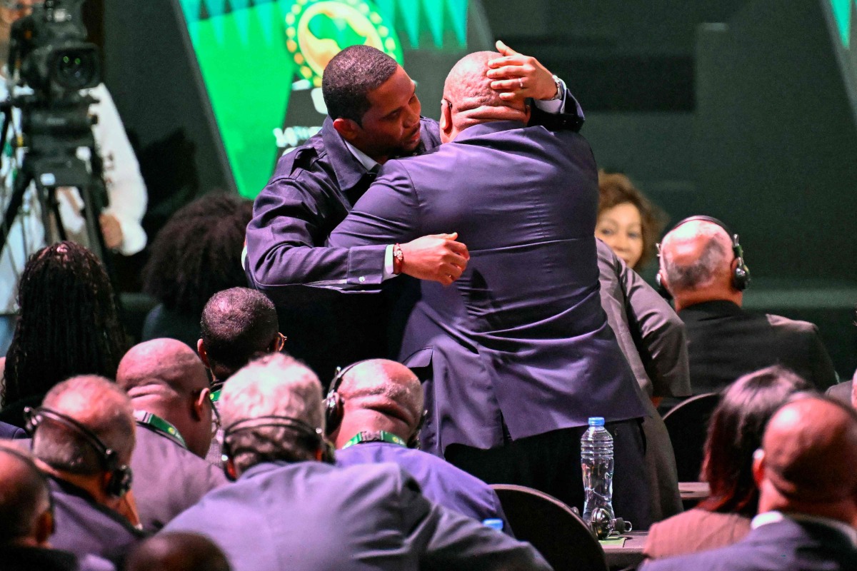 Former Cameroon star Samuel Eto'o (L) is greeted during the Confederation of African Football (CAF) general assembly and the election of a new executive committee, in Cairo, on March 12, 2025. (Photo by Khaled DESOUKI / AFP)