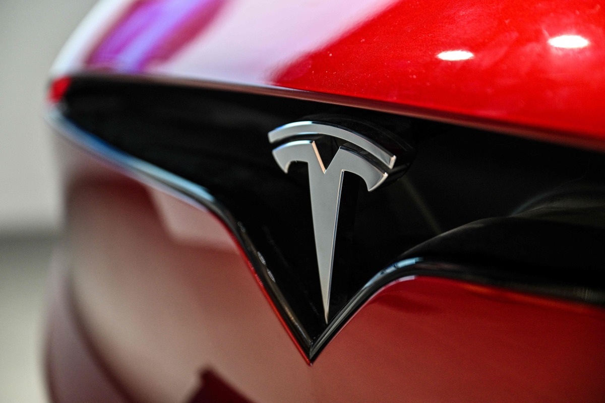 A Tesla Model X car is seen at a showroom for the US electric vehicle maker in the Jing'an district of Shanghai on March 11, 2025. (Photo by HECTOR RETAMAL / AFP)