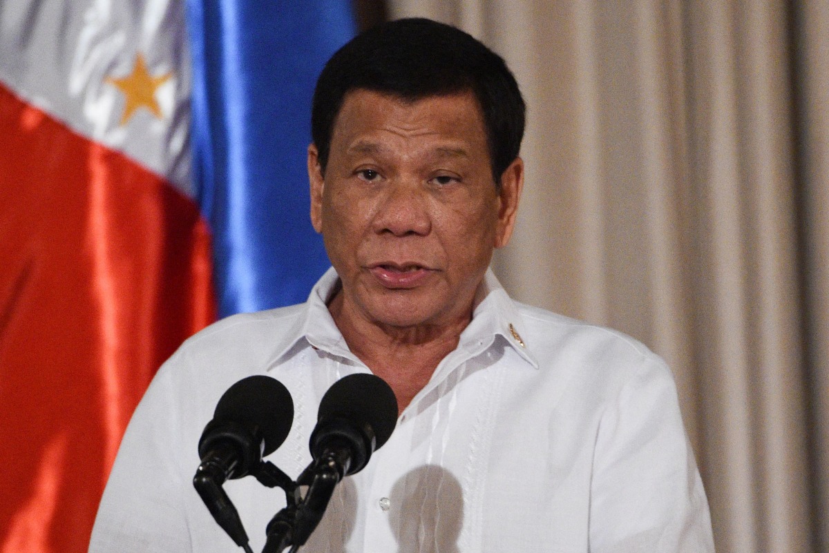 (FILES) Philippine President Rodrigo Duterte delivers his speech during the presentation ceremony of the signed document on the Organic Law for Bangsamoro Autonomous Region of Muslim Mindanao to officials of the Moro Islamic Liberation Front (MILF) at Malacanang palace in Manila on August 6, 2018. (Photo by TED ALJIBE / AFP)
