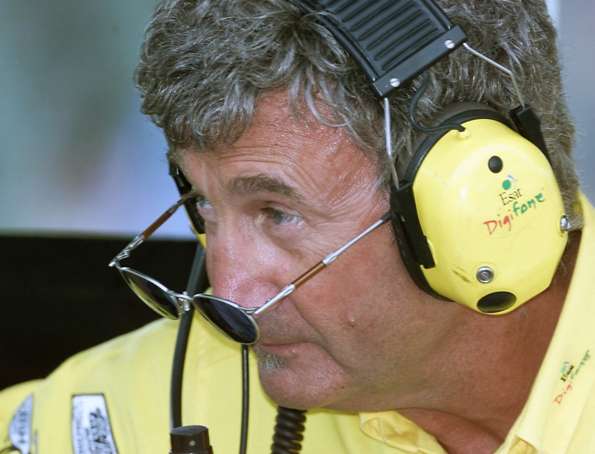 British manager Eddie Jordan looks upon his sunglasses in the pits of the Hungaroring racetrack during the first free practice session, on August 11, 2000, two days before the Hungarian Formula One Grand Prix in Budapest. Photo by Patrick HERTZOG / AFP