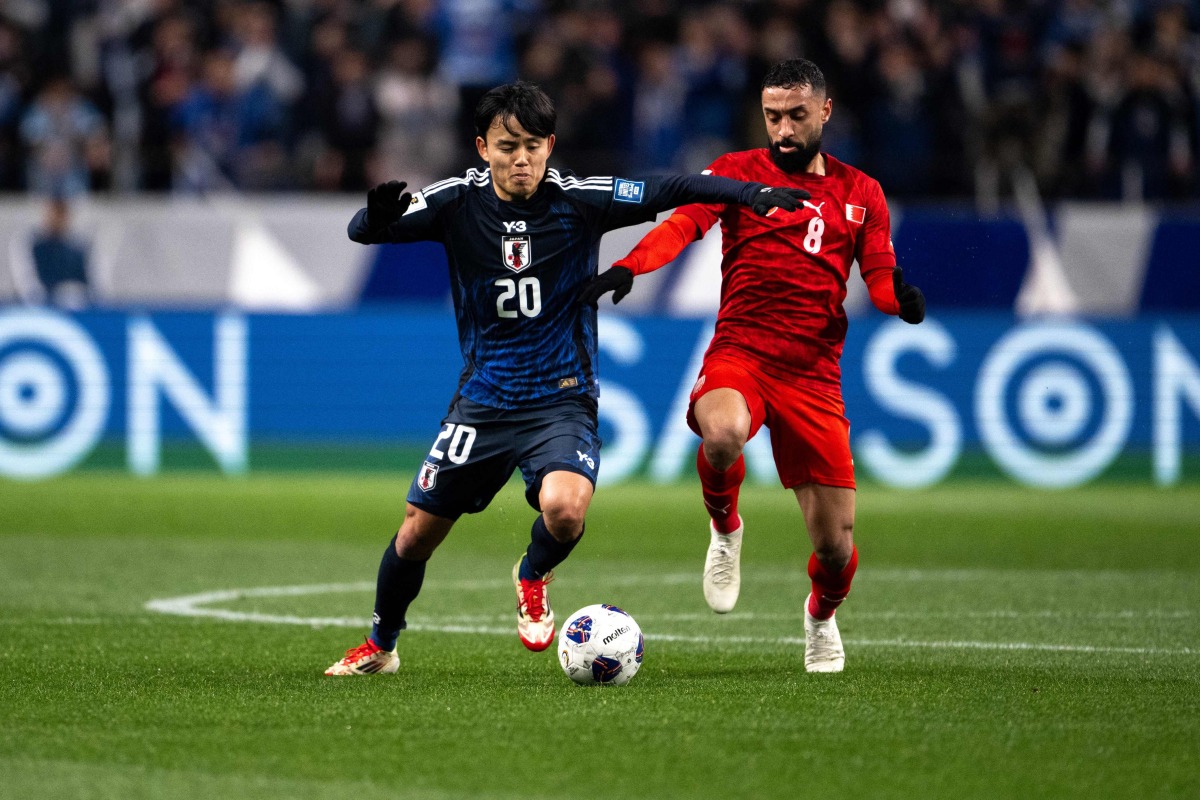 Japan's Takefusa Kubo (L) and Bahrain's Mohamed Marhoon compete for the ball during the 2026 FIFA World Cup Asian qualification football match between Japan and Bahrain in Saitama on March 20, 2025. (Photo by Philip FONG / AFP)