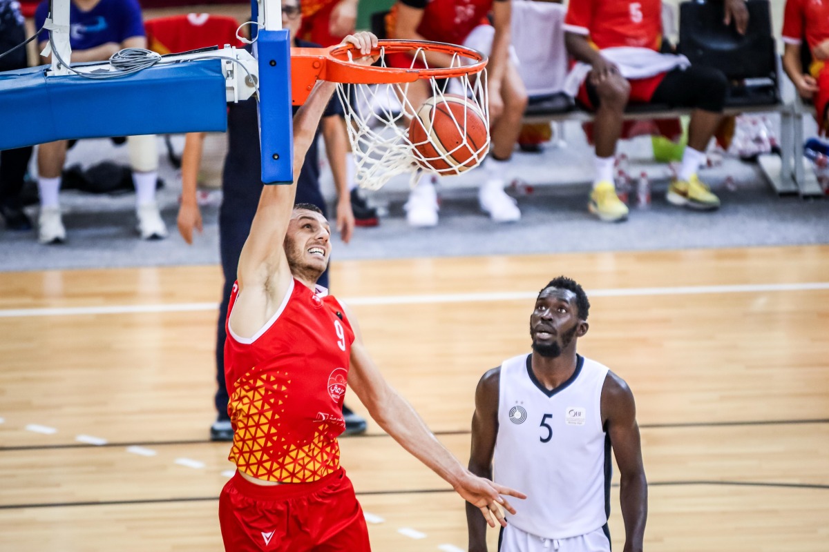 Al Arabi's Elmedin Kikanovic dunks the ball during the match.