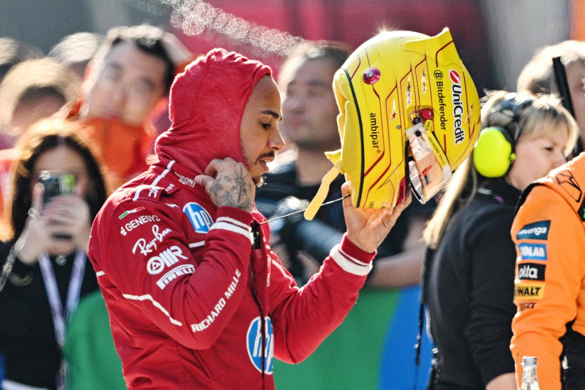 Ferrari's British driver Lewis Hamilton is seen in the pit lane after taking pole position after the sprint qualifying session of the Formula One Chinese Grand Prix at the Shanghai International Circuit in Shanghai on March 21, 2025. (Photo by Hector RETAMAL / AFP)