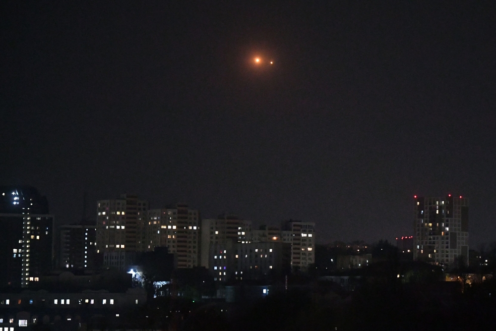 Ukrainian air defence opens fire to drones during an attack in Kyiv on late March 22, 2025, amid the Russian invasion of Ukraine. (Photo by Sergei Supinsky / AFP)