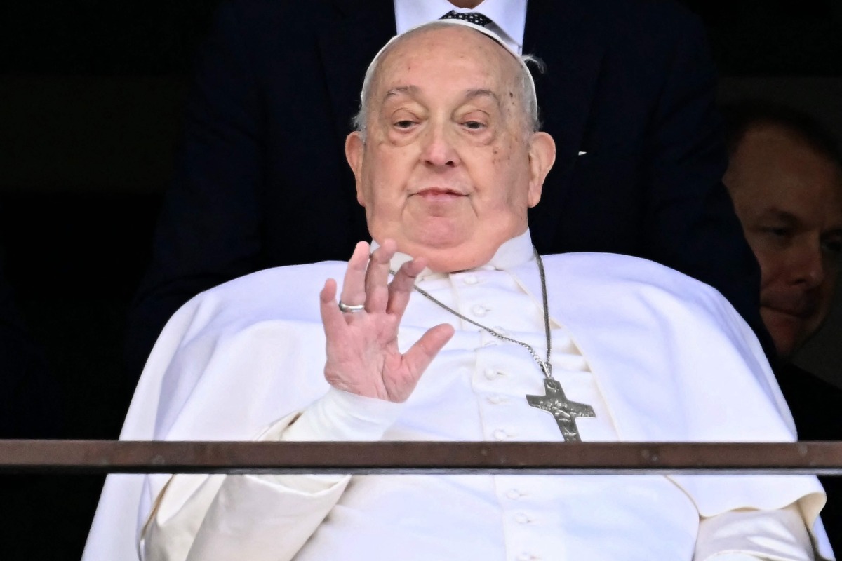 Pope Francis waves from a window of the Gemelli hospital before being discharged following a five weeks hospitalization for pneumonia, in Rome on March 23, 2025. Photo by Filippo MONTEFORTE / AFP