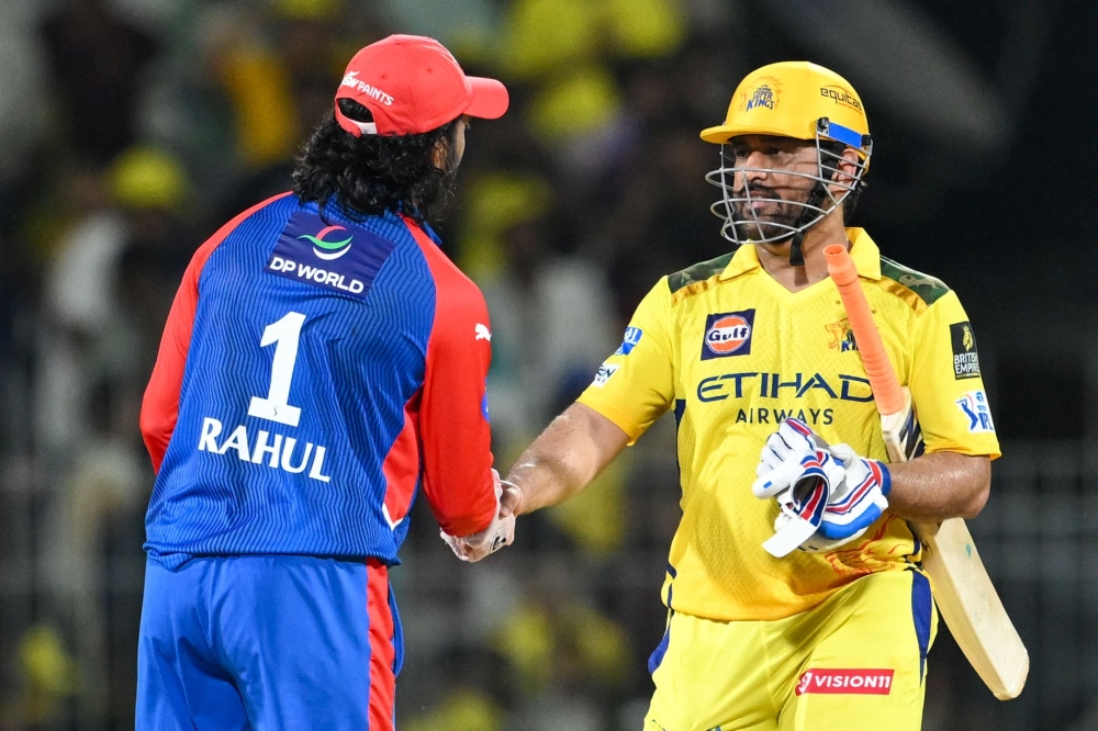 Chennai Super Kings' Mahendra Singh Dhoni (R) greets Delhi Capitals' KL Rahul at the end of the Indian Premier League (IPL) Twenty20 cricket match between Chennai Super Kings and Delhi Capitals at the MA Chidambaram Stadium in Chennai on April 5, 2025. (Photo by R.Satish Babu / AFP)