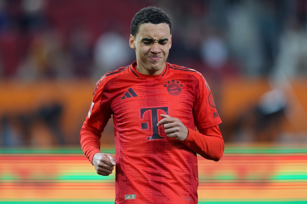 Bayern Munich's German midfielder #42 Jamal Musiala reacts after sustaining an injury during the German first division Bundesliga football match between FC Augsburg and FC Bayern Munich in Augsburg, southern Germany, on April 4, 2025. (Photo by Alexandra BEIER / AFP) 