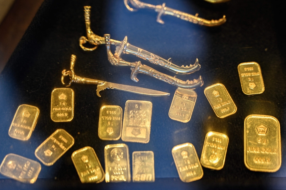 Gold bullions and jewellery are seen on display at a market place in Banda Aceh on April 14, 2025. (Photo by Chaideer Mahyuddin / AFP)